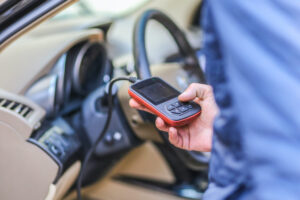 Mechanic using OBD2 diagnostic tool